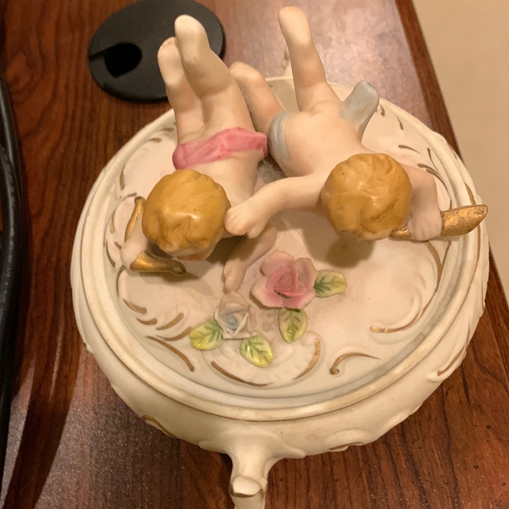 Vintage porcelain trinket box with cherubs on the top